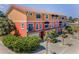 Multi-story building featuring a colorful exterior, arched windows, balconies, and lush tropical landscaping at 47 W Morgan St, Tarpon Springs, FL 34689