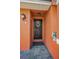 Inviting entryway with a black front door, decorative wreath, and a charming exterior light fixture at 47 W Morgan St, Tarpon Springs, FL 34689