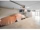 Spacious garage with a car under a cover, built-in storage, and bright lighting at 47 W Morgan St, Tarpon Springs, FL 34689