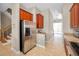 Spacious kitchen with stainless steel appliances, wooden cabinets and a staircase to the side at 47 W Morgan St, Tarpon Springs, FL 34689