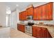 Well-equipped kitchen with stainless steel appliances, granite countertops, and wood cabinets at 47 W Morgan St, Tarpon Springs, FL 34689