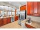 Well lit kitchen features stainless steel appliances, wooden cabinets, and granite countertops at 47 W Morgan St, Tarpon Springs, FL 34689