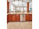 Open kitchen featuring stainless steel appliances, wooden cabinetry, and views of the dining room at 47 W Morgan St, Tarpon Springs, FL 34689