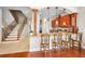 Open-concept kitchen and staircase with granite countertops and wooden cabinetry at 47 W Morgan St, Tarpon Springs, FL 34689