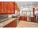 This open kitchen features stainless appliances, granite countertops, tile floors, and cherry wood cabinets at 47 W Morgan St, Tarpon Springs, FL 34689