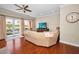 Cozy living room area with hardwood floors, ceiling fan and view of the water from the balcony at 47 W Morgan St, Tarpon Springs, FL 34689