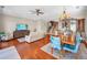 Open concept living area with hardwood floors, stairs, dining table and view into kitchen area at 47 W Morgan St, Tarpon Springs, FL 34689