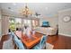 Open-concept living room featuring a dining area with hardwood floors and views of the outdoor greenery at 47 W Morgan St, Tarpon Springs, FL 34689