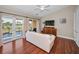 Bright main bedroom sitting area with water views, wooden floors, and mounted TV at 47 W Morgan St, Tarpon Springs, FL 34689