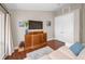 Spacious main bedroom sitting area with wooden floors, storage, and mounted TV at 47 W Morgan St, Tarpon Springs, FL 34689