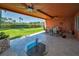 Covered patio with a ceiling fan, dining table and chairs, and a view of the lawn at 47 W Morgan St, Tarpon Springs, FL 34689
