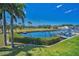 Scenic view of the community's pond, surrounded by lush landscaping and palm trees on a sunny day at 47 W Morgan St, Tarpon Springs, FL 34689