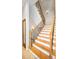 Elegant staircase featuring wooden steps, iron balusters, and a classic design at 47 W Morgan St, Tarpon Springs, FL 34689