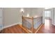 This staircase features hardwood steps, decorative railing, and sconce lighting at 47 W Morgan St, Tarpon Springs, FL 34689