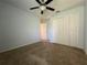 Bedroom with ceiling fan and double closets, perfect for customization at 4908 Babbling Brook Ln, Wimauma, FL 33598