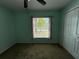 This bedroom features a ceiling fan and a window that brings in natural light at 4908 Babbling Brook Ln, Wimauma, FL 33598