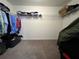 Walk-in closet with shelves and hanging clothes at 4908 Babbling Brook Ln, Wimauma, FL 33598