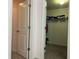 Walk-in closet with a door and clothes inside at 4908 Babbling Brook Ln, Wimauma, FL 33598
