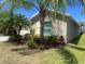 Well-maintained home featuring manicured landscaping and mature palm trees at 4908 Babbling Brook Ln, Wimauma, FL 33598
