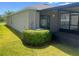 Exterior view of a home showing a patio and manicured lawn at 4908 Babbling Brook Ln, Wimauma, FL 33598