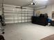 Spacious two car garage with an automatic door and plenty of space for storage at 4908 Babbling Brook Ln, Wimauma, FL 33598