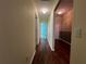 Hallway with laminate flooring and neutral walls, leading to various rooms at 4908 Babbling Brook Ln, Wimauma, FL 33598