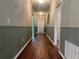 Inviting hallway with decorative paneling, providing access to multiple rooms in the house at 4908 Babbling Brook Ln, Wimauma, FL 33598