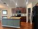 Spacious kitchen featuring a large island, granite countertops, and a convenient walk-in pantry at 4908 Babbling Brook Ln, Wimauma, FL 33598