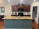 Eat-in kitchen features dark wood cabinetry, granite countertops, a large island, and walk-in pantry at 4908 Babbling Brook Ln, Wimauma, FL 33598