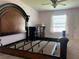Bedroom features a dark wood bed frame, neutral walls, carpet, and a large window for natural light at 4908 Babbling Brook Ln, Wimauma, FL 33598