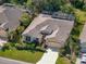 An aerial view of a one-story house featuring a well-maintained yard, screened-in pool, neutral-colored stucco, and lush landscaping at 4942 Oldham St, Sarasota, FL 34238