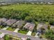 Aerial view of a home with screened in lanai backing up to a wooded area at 4942 Oldham St, Sarasota, FL 34238