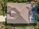 Aerial view of the roof and screened-in lanai of a home with manicured landscaping at 4942 Oldham St, Sarasota, FL 34238