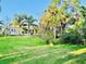 Expansive backyard with lush green grass and mature tropical trees, ideal for outdoor enjoyment at 4942 Oldham St, Sarasota, FL 34238