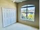 Cozy bedroom with large window offering ample natural light and a view of the outdoors at 4942 Oldham St, Sarasota, FL 34238