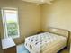 Cozy bedroom features a large window offering natural light and closet for storage at 4942 Oldham St, Sarasota, FL 34238