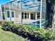 Landscaped view of the screened-in pool area and patio at 4942 Oldham St, Sarasota, FL 34238