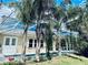 A picturesque pool view framed by tall palm trees, within a screened enclosure at 4942 Oldham St, Sarasota, FL 34238