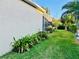 Well-maintained side yard featuring lush landscaping and a view of the screened in patio at 4942 Oldham St, Sarasota, FL 34238