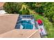 Aerial view of screened pool with spa, deck, outdoor seating, and red umbrella at 5004 Waterkey Way, Tampa, FL 33647