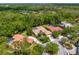 Aerial view showcasing homes with private pools surrounded by lush greenery in a neighborhood at 5004 Waterkey Way, Tampa, FL 33647
