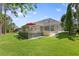 A spacious backyard with a deck, screened-in pool, and lush green lawn at 5004 Waterkey Way, Tampa, FL 33647