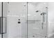 Bright bathroom featuring a glass enclosed shower with marble style tile and a built-in seat at 5004 Waterkey Way, Tampa, FL 33647