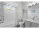 Bathroom with a tub and shower, a vanity, modern fixtures, and coastal decor at 5004 Waterkey Way, Tampa, FL 33647