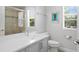 Bathroom with a vanity, modern fixtures, and a shower with glass doors at 5004 Waterkey Way, Tampa, FL 33647