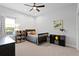 Bedroom featuring neutral colors, built-in bookcases, and a bed beneath a ceiling fan at 5004 Waterkey Way, Tampa, FL 33647