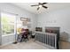 Bedroom featuring neutral colors, a desk, and a bed beneath a ceiling fan at 5004 Waterkey Way, Tampa, FL 33647