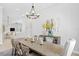 Bright dining room showcases chandelier, table with seating, artwork, and view to the living area at 5004 Waterkey Way, Tampa, FL 33647