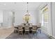 Elegant dining room features stylish chandelier, patterned rug, and an artful buffet under a decorative painting at 5004 Waterkey Way, Tampa, FL 33647