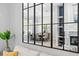 Large black framed mirror reflecting the dining room and fireplace beyond the adjacent living room at 5004 Waterkey Way, Tampa, FL 33647